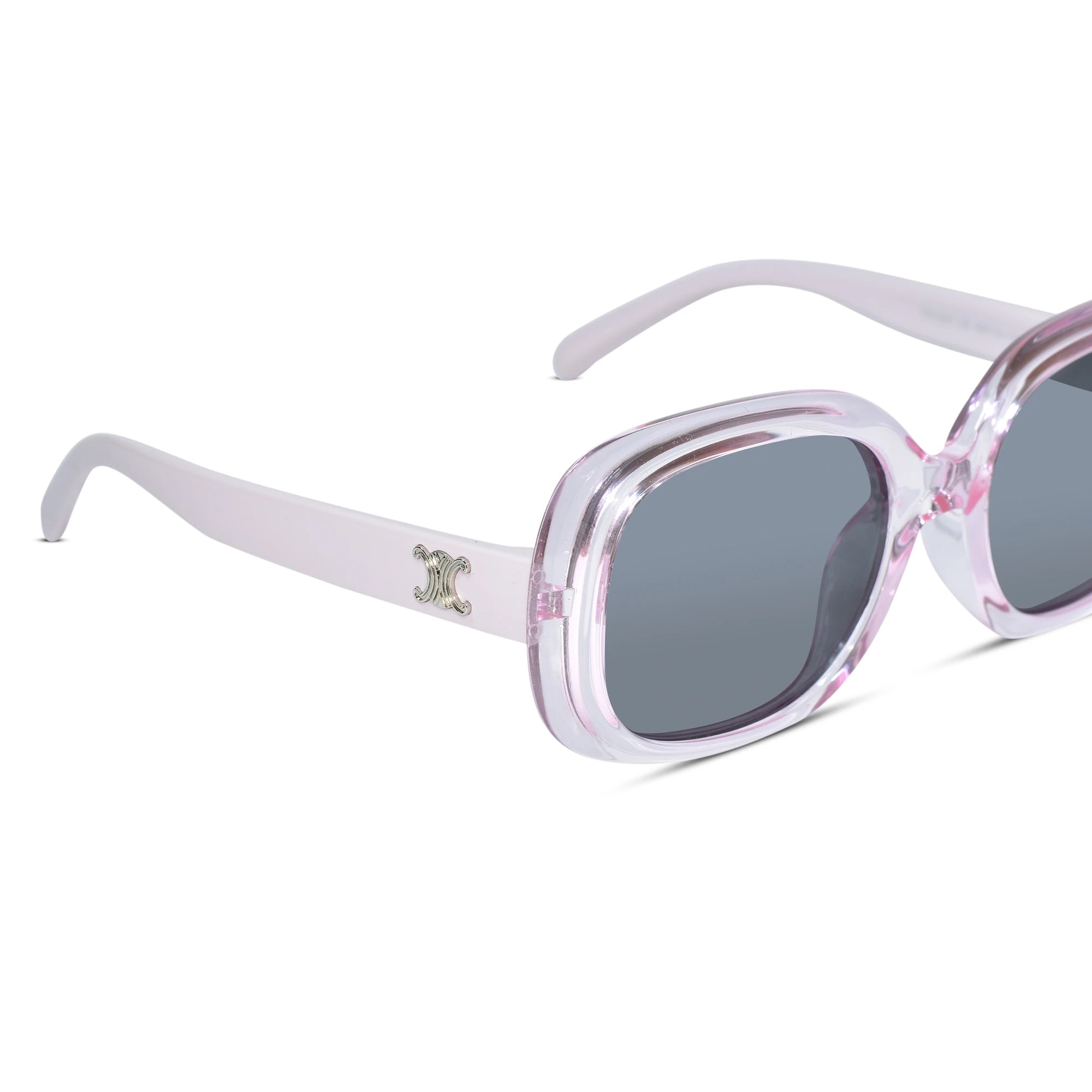 A pair of oversized square sunglasses with a translucent light pink and white frame, dark gray lenses, and a small silver-toned logo charm on the temple arm, shown against a plain white background.