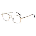A pair of semi-rimless metal eyeglasses with a gold-tone frame and black temple tips, shown on a plain white background.