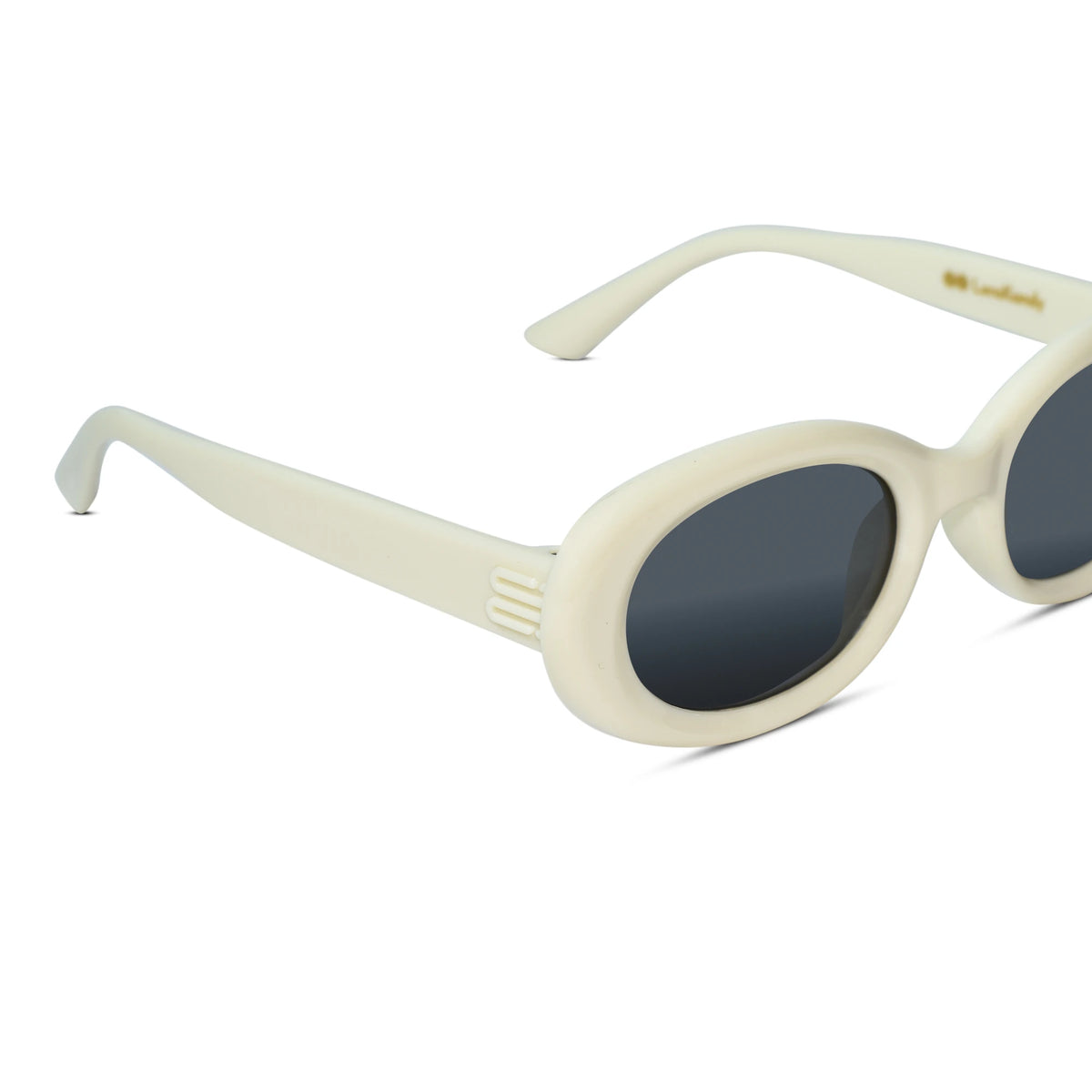 Cream-colored oval sunglasses with dark gray lenses, shown from a three-quarters angle on a white background.