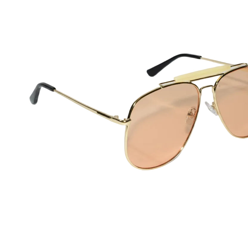 Gold-framed sunglasses with pink-tinted lenses on a light gray background