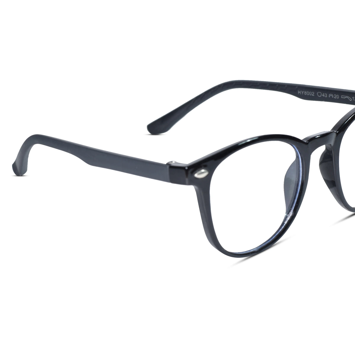 A close-up shot of a pair of eyeglasses with a glossy black acetate frame, featuring clear lenses and visible temple arm text reading 'STUNN CHS PRN'.