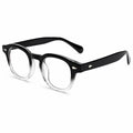 Black and clear gradient acetate eyeglasses with clear lenses, shown at a three-quarter angle on a white background.