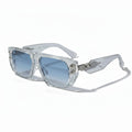 Clear frame sunglasses with blue lenses on a white background