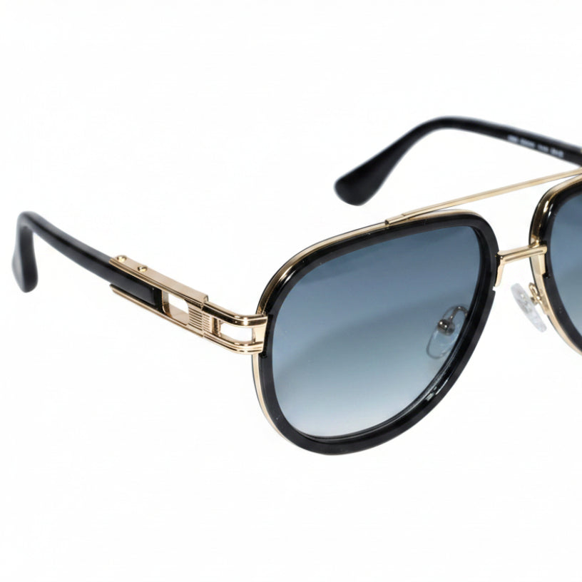 A pair of aviator-style sunglasses with black acetate frames, gold metal double bridge and hinge details, and blue gradient lenses, shown on a light gray background.